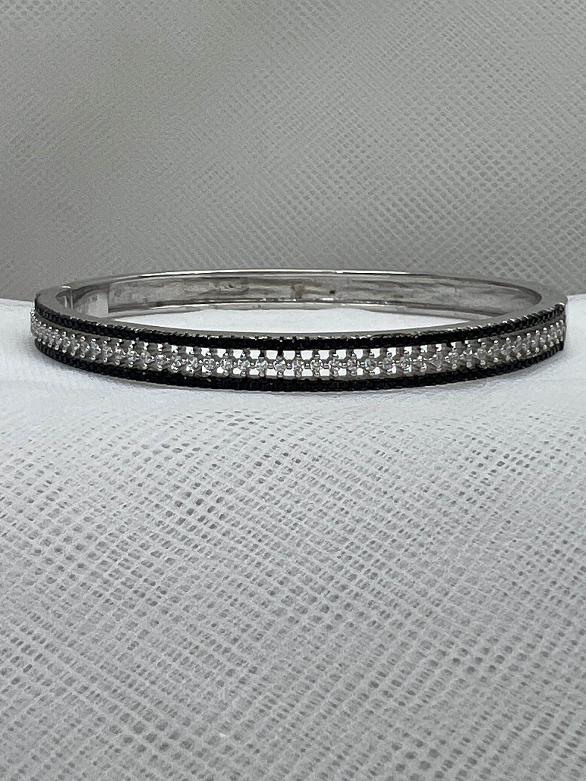 Esclava de plata con circonitas blancas y negras rodidada en oro blanco