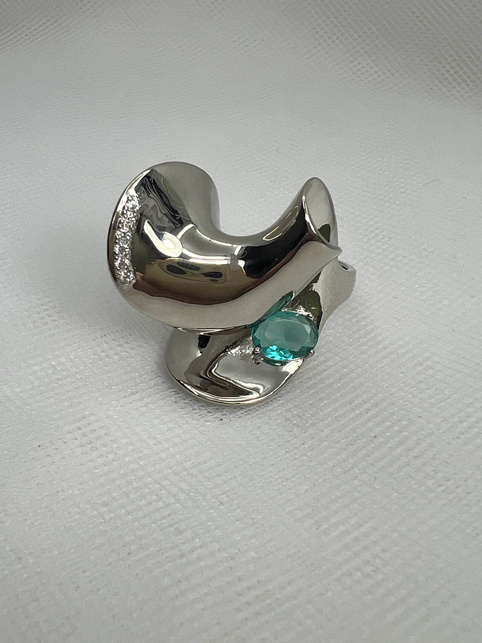 Anillo de plata rodiado en oro blanco con circonita verde y blancas.
