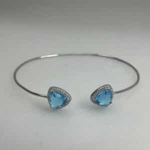 Esclava de plata rodiada en oro blanco con circonitas blancas y azules.